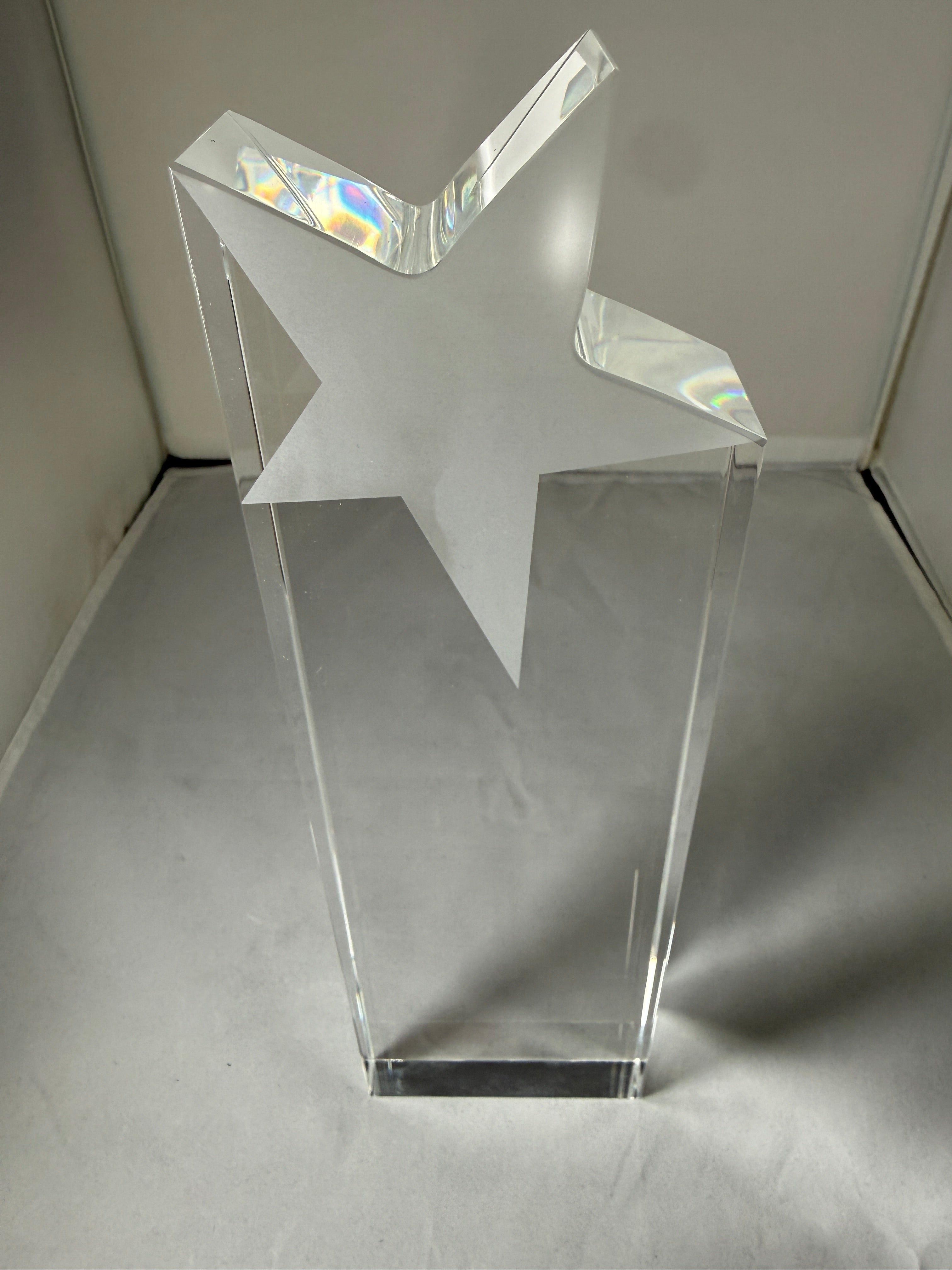 Clear star-shaped object on a gray background